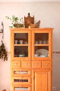 a wooden cabinet with dishes on top of it at Quinta Amarela - B&B in Nazaré