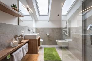 een badkamer met een wastafel, een toilet en een douche bij Haus Pötzes in Castelrotto +48 foto's