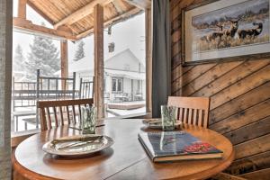 a wooden table with plates and glasses on it in a cabin at Cozy Log Cabin Escape In the Heart of Creede! in Creede
