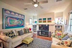 a living room with two couches and a fireplace at Colorful Pensacola Oasis 1 Block to Bayview Park! in Pensacola