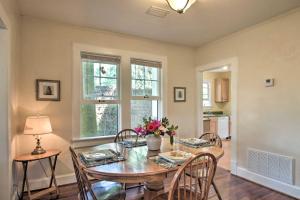 a dining room with a table and chairs and a window at Colorful Pensacola Oasis 1 Block to Bayview Park! in Pensacola +16 photos