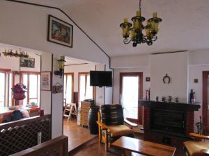 a living room with a fireplace and a dining room at Casa Emanuela 1 in Baiardo