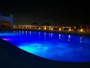 a swimming pool at night with blue lights at Puerto Las Hadas Apartamentos 1065-1063-764 in Manzanillo