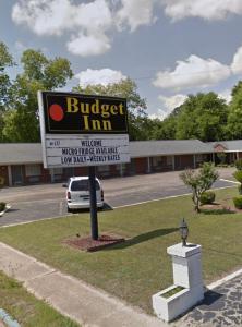 a building with a sign for a burger inn at Budget Inn in Monroeville