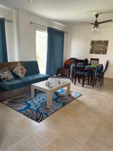 a living room with a couch and a coffee table at شاليه أرضي بجنينه في مارينا وادي دجله العين السخنه Three Bedroom Chalet with Garden In Marina Wadi Degla Ain El Sokhna - For Families Only in Ain Sokhna