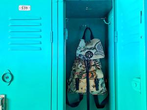 a dress in a closet with a blue door at Paris Hostel in Tijuana