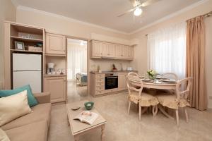 a kitchen and living room with a couch and a table at Nostalgia Corfu Town Apartments in Corfu Town