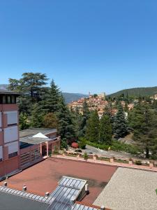 a building with a roof with a view of a city at Les Thermes de Vernet-les-bains in Vernet-les-Bains +9 photos