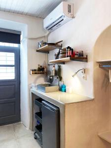 a kitchen with a sink and a counter top at Bougainvillea Friends & Family Studio - Old Town in Mikonos +10 photos