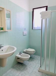 a bathroom with a sink and a toilet at Margherita 8 Apartments in Rimini