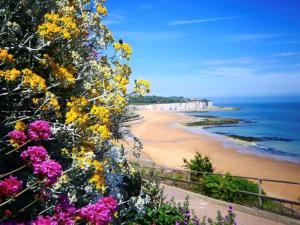 a view of a beach with flowers at Little Flint in Kent