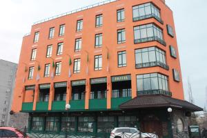 a large orange building with a hotel at O'Hara in Voronezh