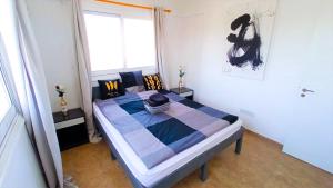 a bedroom with a bed in a room with a window at Luxury Maisonette Apartment -SEA VIEW, NETFLIX, GYM- 5 Min from Beach in Larnaka