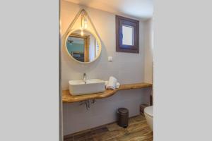 a bathroom with a sink and a mirror at Melina's cosy appartment in Argalasti