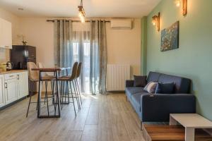 a living room with a couch and a table at Melina's cosy appartment in Argalasti