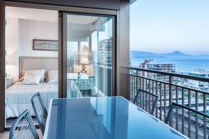 a balcony with a bed and a view of the ocean at GLP Dreams Torre Alazan in Alicante