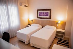 Postel nebo postele na pokoji v ubytování Charrua Hotel