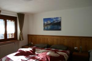 una camera con un letto e una foto appesa al muro di Furggen a Valtournenche