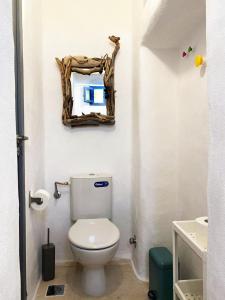 a bathroom with a toilet and a mirror on the wall at Bougainvillea Friends & Family Studio - Old Town in Mikonos
