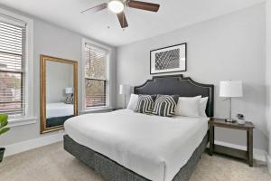 a white bedroom with a large bed and a mirror at 3BR Apartment with Wi-Fi, Close to Shops & Dining! - Lincoln 3 in Chicago