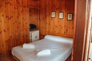 a bedroom with two beds in a wooden room at Camping La Aldea in El Rocío