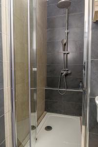 a shower with a glass door in a bathroom at Melina's Studios in Argalasti
