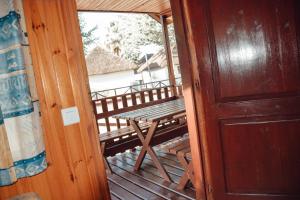 
a wooden door leading to a cabin with a view of the water at Camping La Aldea in El Rocío
