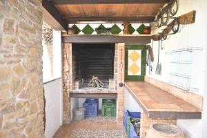 an outdoor pizza oven with a stone wall at Mas de Josep in L'Ampolla
