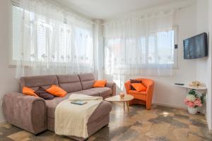 a living room with a couch and a chair at Apartment Adria in Dubrovnik