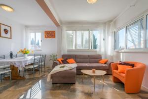 a living room with a couch and a table at Apartment Adria in Dubrovnik