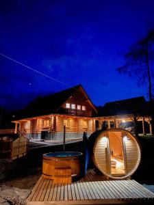 a wooden deck with a hobbit house at night at Chata Nad Potokiem w Górach in Kamesznica