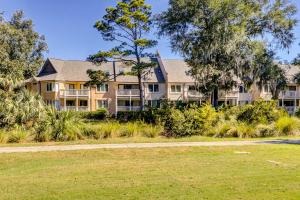 a large apartment building with a lawn in front of it at Colonnade Club 152 in Hilton Head Island