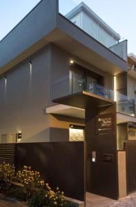 a large building with a balcony and a fence at RICCIONE SUITE DESIGN in Riccione