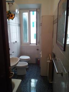 a bathroom with a toilet and a sink and a window at La Casa alla Basilica in Rome