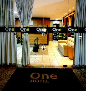a one hotel lobby with a one hotel sign on the window at One Hotel in João Pessoa