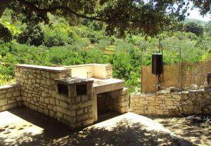 a stone kitchen with a sink in a yard at Holiday home Lidija - Robinson House in Postira