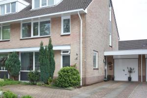a brick house with a white garage at Teska Bed & Breakfast in Veenendaal