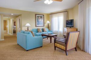 a living room with two blue couches and a table at Club Wyndham Bonnet Creek in Orlando