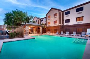 a swimming pool with chairs and a building at Best Western Downtown Phoenix in Phoenix