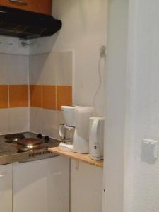 a kitchen with a counter top with a coffee maker at Babel in Trier