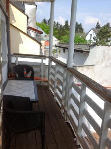 a balcony with a table and chairs on a building at Babel in Trier