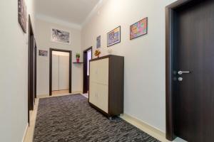 a hallway with a row of doors and a closet at Apartments Pully in Dubrovnik