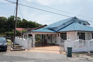 a house with a blue roof and a white fence at Beit Azzahra Private Pool Villa at Pantai Batu Hitam in Kuantan