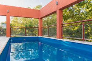 a swimming pool in a house with windows at Hotel Cerro Blanco in San Juan