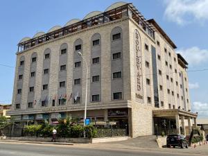 a large building on the corner of a street at Boulevard Palace Hotel in Monrovia