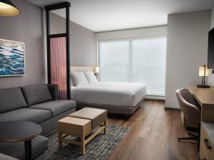 a hotel room with a bed and a couch at The Forester Hotel, part of Unscripted by Hyatt in Lake Forest +85 photos