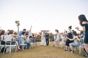 a bride and groom walking down the aisle at their wedding ceremony at Bay Forest Boutique B&B in Hengchun