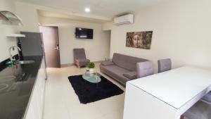 a living room with a couch and a table at Condominios Costa Diamante in San Carlos