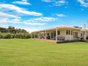 a white house with a large lawn in front of it at Kilcunda Coast House in Woolamai