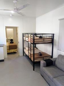 a living room with bunk beds and a couch at Oasis Tourist Park in Palmerston